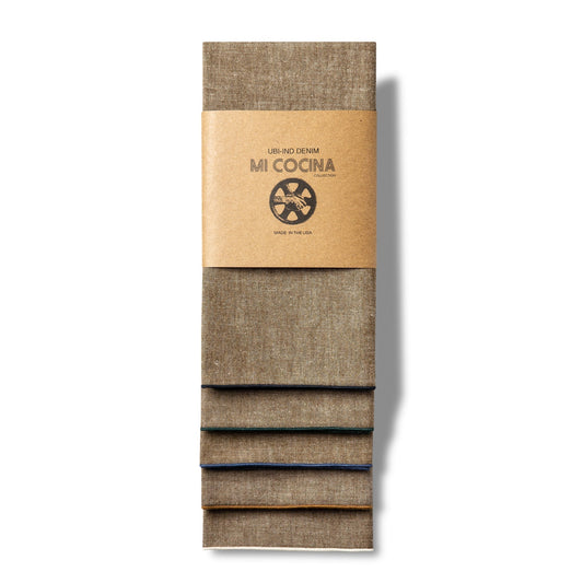 Tan chambray cotton napkin with heathered texture and contrast stitching